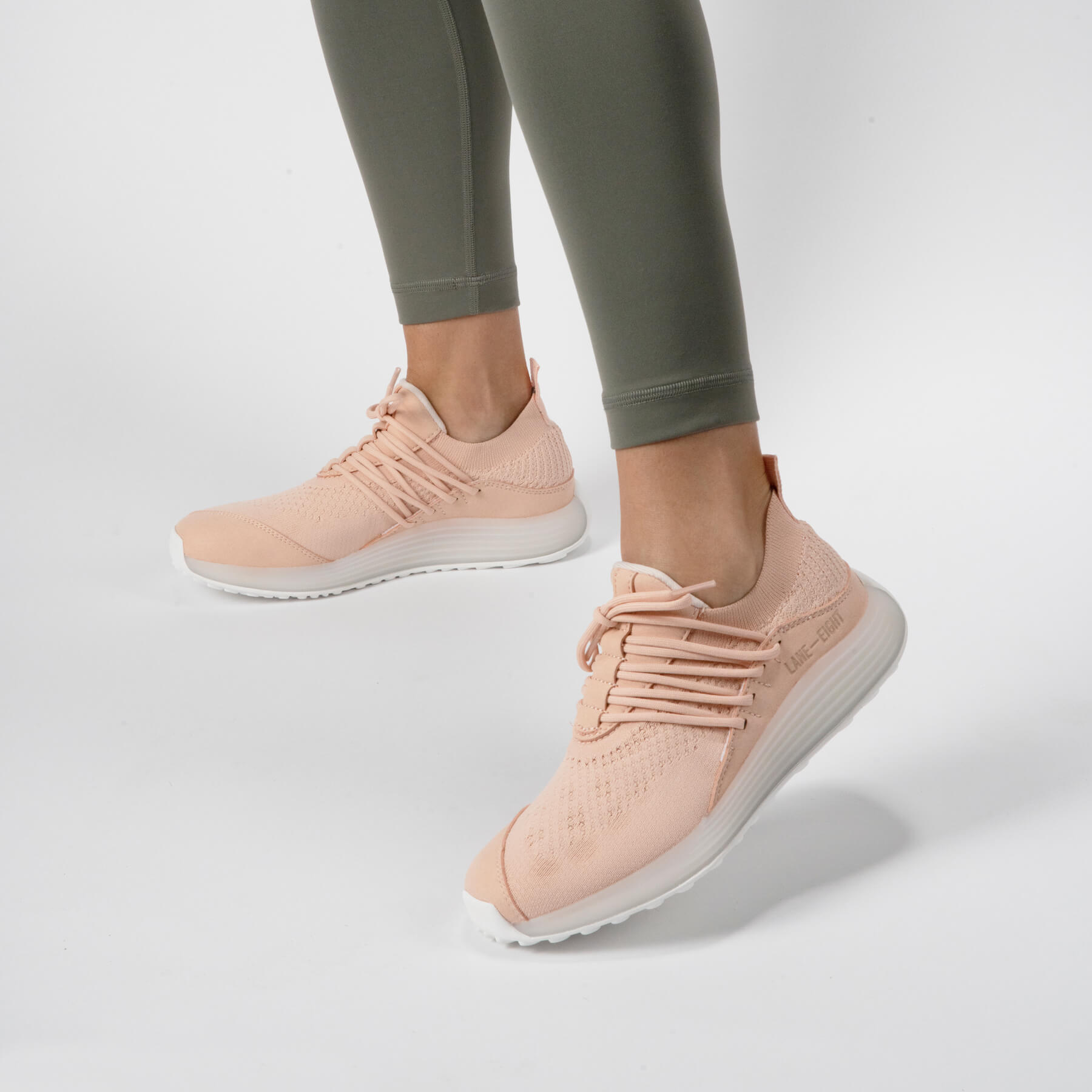 LANEEIGHT-TRAINER-AD-1-PinkSand-WomensOnFoot.jpg